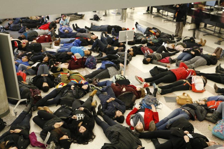 A group of about 70 multicultural students silently lie on the floor of Parks Library. Around 200 students and community members gathered in a silent demonstration Dec. 10 at Parks Library. The protestors lay on the ground to signify the death of Michael Brown, a teenager who was fatally shot in Ferguson, Mo. The lifeless body of Brown was left for about four hours on the streets of Ferguson, sparking nationwide demonstrations in retaliation.