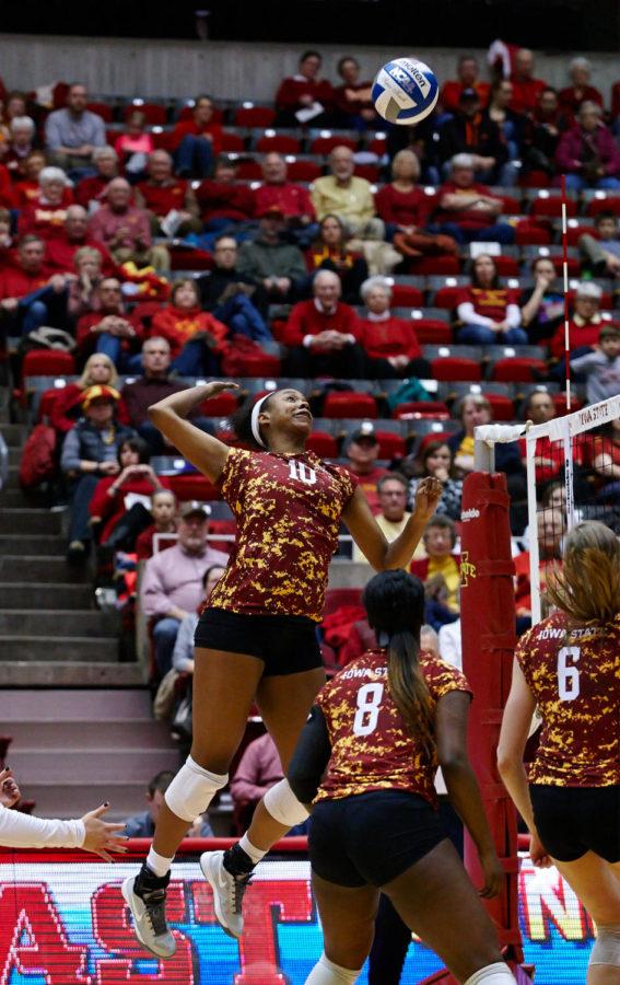 Senior outside hitter Victoria Hurtt leaps up to spike the ball past the waiting TCU defenders. Iowa State won this Nov. 15 match 3-2 against TCU after five close sets.