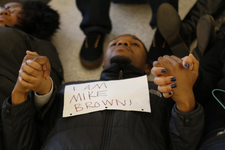 At the end of the demonstration, protestors held hands on the ground as a symbol of solidarity. Around 200 students and community members gathered in a silent demonstration Wednesday morning. The protestors lay on the ground to signify the death of Michael Brown, a teenager who was fatally shot in Ferguson, Mo. The lifeless body of Brown was left for about four hours on the streets of Ferguson, sparking nationwide demonstrations in retaliation.