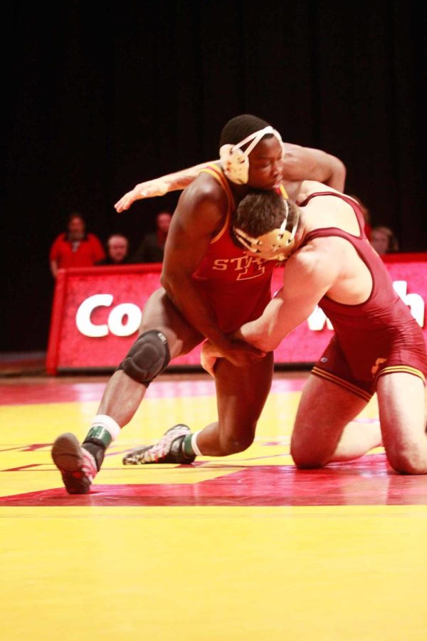 Red+shirt+junior+Kyven+Gadson+takes+down+his+opponent.+He+won+the+match+by+decision+with+a+final+of+6-4%2C+but+the+Cyclones+fell+to+the+Gophers+with+a+final+of+27-12.