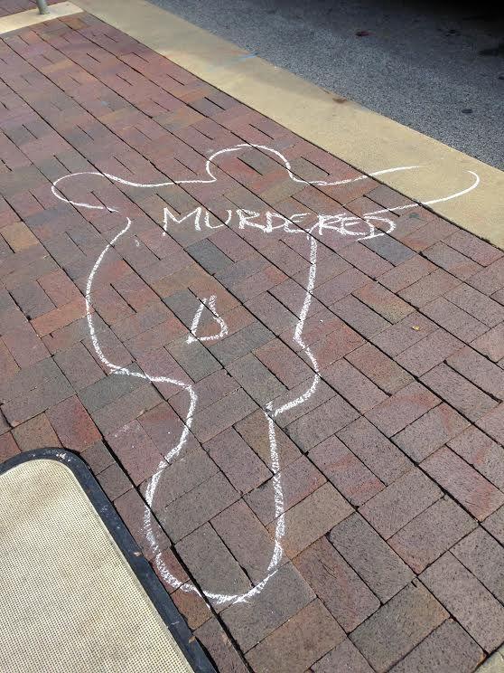 People in Kansas City, Mo., draw chalk lines around their bodies Nov. 28 in protest to the grand jury decision to not indict officer Darren Wilson, who shot 18-year-old Michael Brown in August. 