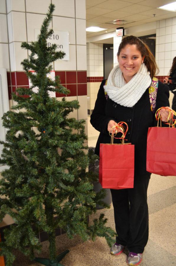 Lindsay Richmond, freshman in animal science, is one of the many students that is donating to the less fortunate children of Ames. YWCA and the Faculty Senate are coming together to help less fortunate children in Ames receive Christmas gifts. The tree in LeBaron is empty with the giving season around the corner. 