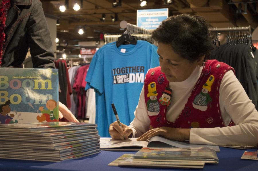 Sarvinder Naberhaus, author of Boom Boom, signs books for fans at the Memorial Union on Dec. 6. Naberhaus book is aimed at children and she has also coauthored another childrens book with Roger Kluesner.