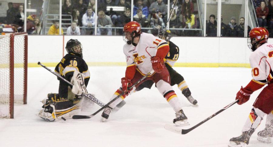 Junior forward J.P. Kascsak attempts a goal against Iowas Alex Wisnousky on Jan. 24, 2014 at the  ISU/Ames Ice Arena. The Cyclones beat the in-state rival 1-0.