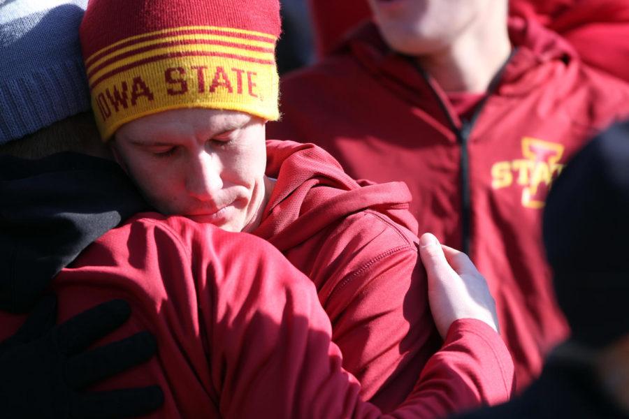 ISU+fans+hug+each+other+after+a+trick-play+pass+was+dropped+during+the+Cyclones+matchup+with+the+No.%C2%A019+Sooners+on+Nov.+1.+The+Cyclones+fell+to+the+Sooners+with+a+final+score+of+59-14.