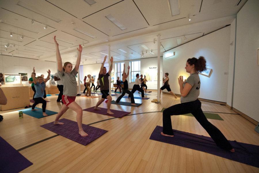 Mahala McDanel, junior in event management, leads an exercise
group in a high lunge yoga pose on Feb. 16, 2012. 
