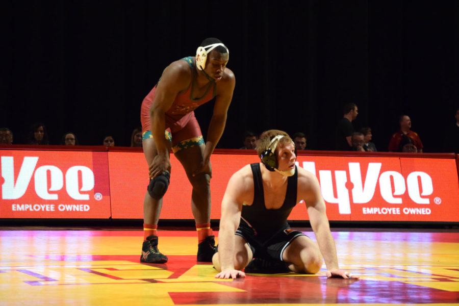 Redshirt senior Kyven Gadson prepares to start the second period with Oklahoma State's Luke Bean. Gadson defeated Bean by fall in the second period.