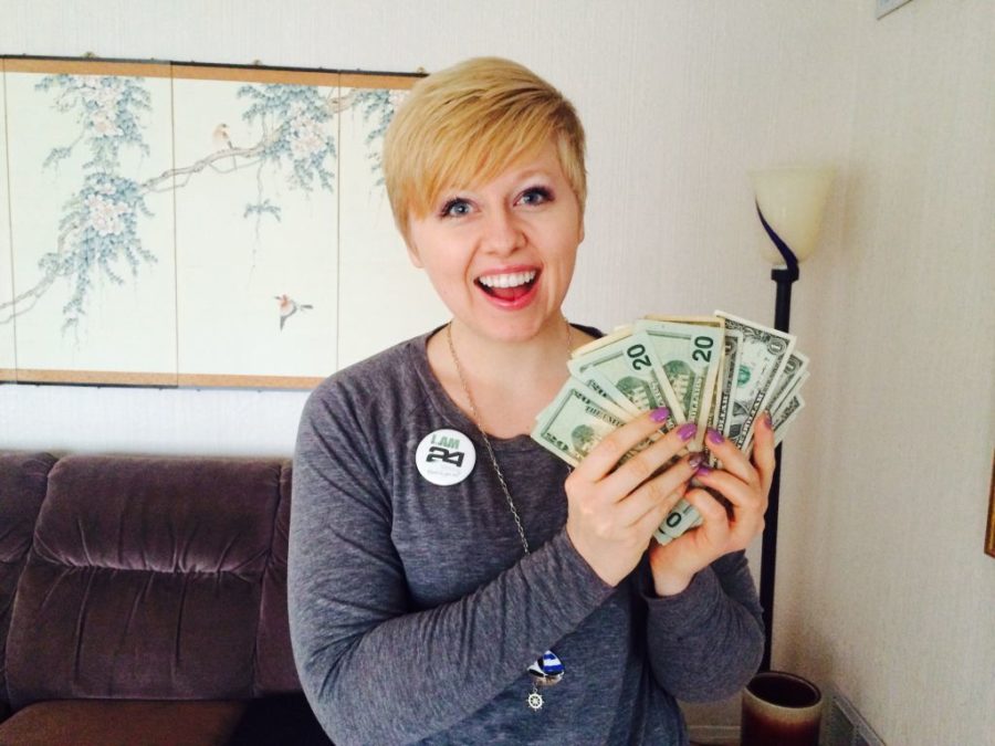 Anna Nygren, a junior in Kinesiology, holds money that can be won from the Power Full Nutrition eight-week challenge.