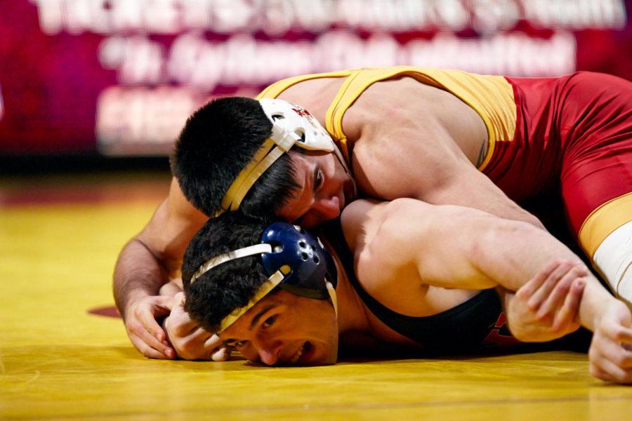 Redshirt sophomore Gabe Moreno pushes Penn sophomore Quinton Hiles into the mat. Moreno won the match and continued Iowa States run to victory over Penn with a final score of 41-3.