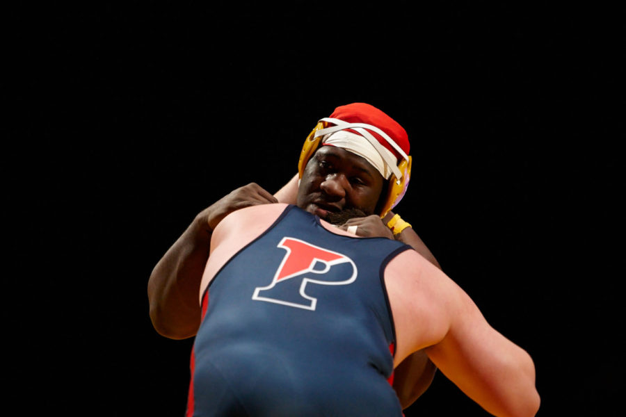 Redshirt sophomore Quean Smith fights to gain an advantage over Penn freshman Patrik Garren in the heavyweight match Jan. 11. Iowa State went on to win the meet against Penn with a final score of 41-3.