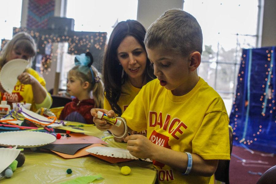 This 6-year-old works on crafts with his mother in the family room at Dance Marathon on Jan. 24. He is a Dance Marathon miracle kid and has been diagnosed with a number of health issues, including generalized anxiety disorder, ADHD and developmental delays. This was the second Dance Marathon that he and his family have participated in.