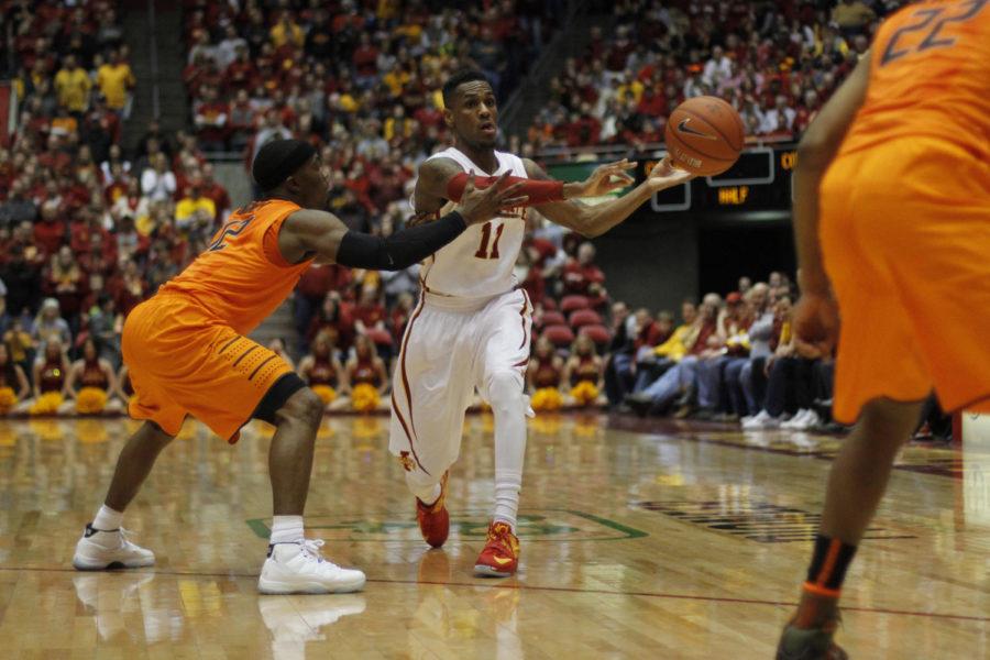 Sophomore guard Monté Morris passes the ball to an open teammate during Iowa States battle with the Oklahoma State Cowboys on Jan. 6. Morris scored eight points with six assists, aiding to a 63-61 victory over the Cowboys, marking Iowa States first Big 12 conference win.