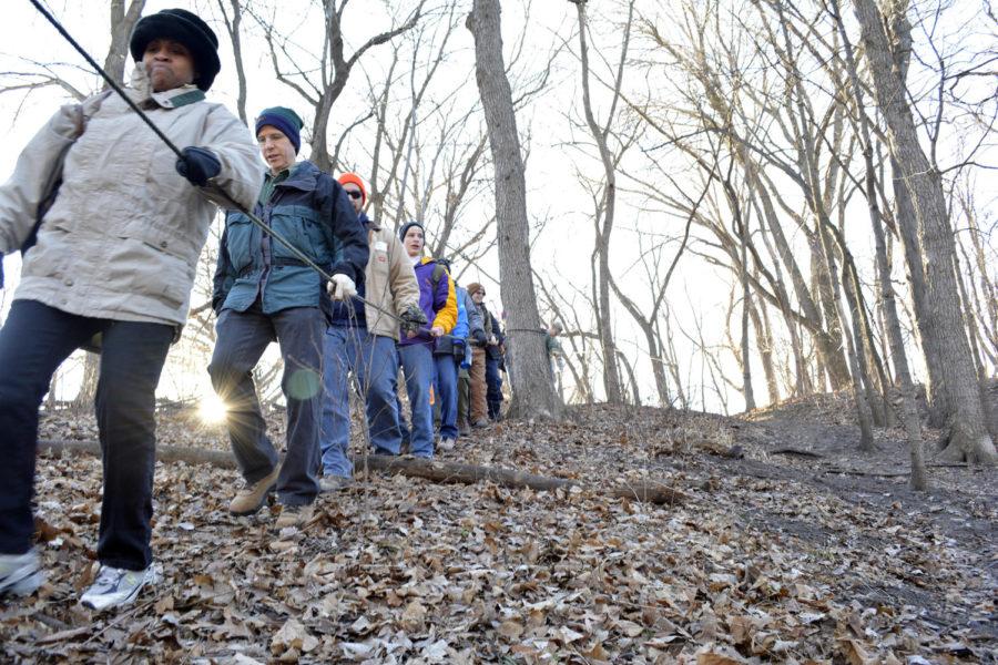 Boy Scouts, troop leaders and parent volunteers trek down a hill into Pammel Woods to participate in the four outdoor sessions of the winter survival training hosted by Army ROTC on Jan. 24. Outdoor sessions included fire and shelter building and water and food procurement.