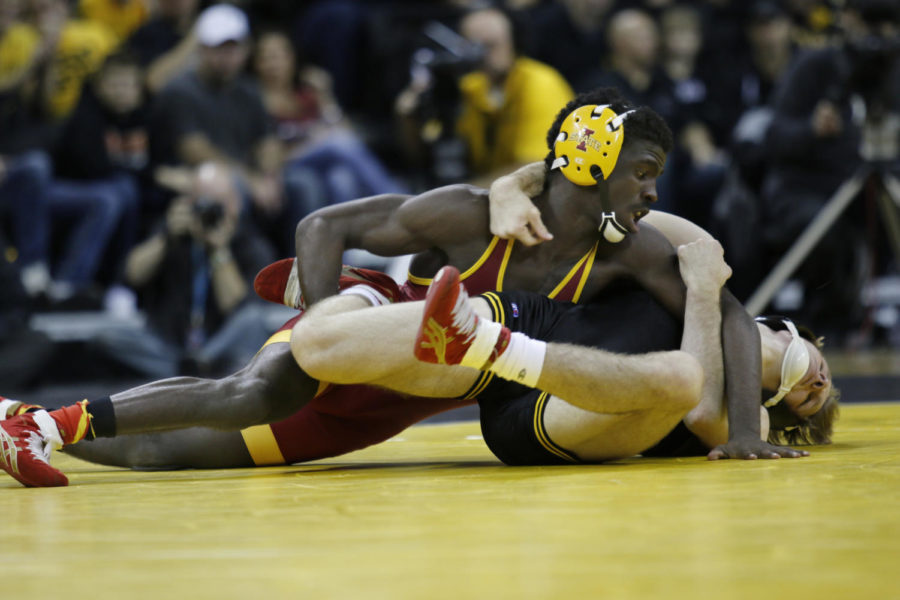 Junior Earl Hall earns a takedown in the first period against Iowa’s Cory Clark. Hall went scoreless for the rest of the 133-pound match losing 8-3 in the Cy-Hawk Series duel which took place on Nov. 29 in Iowa City. The No. 15 Cyclones struggled to secure close matches, falling to rival No. 1 Iowa 28-8.