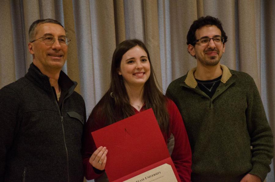 Shelby Hockey, computer science major, accepts the Student Employee of the Year Award from the ISU Financial Aid office. Hockey was accompanied by advisors of the Computer Science Department, who nominated her for the award. The award honors "reliability, quality of work, professionalism, and uniqueness of contribution to Iowa State University."