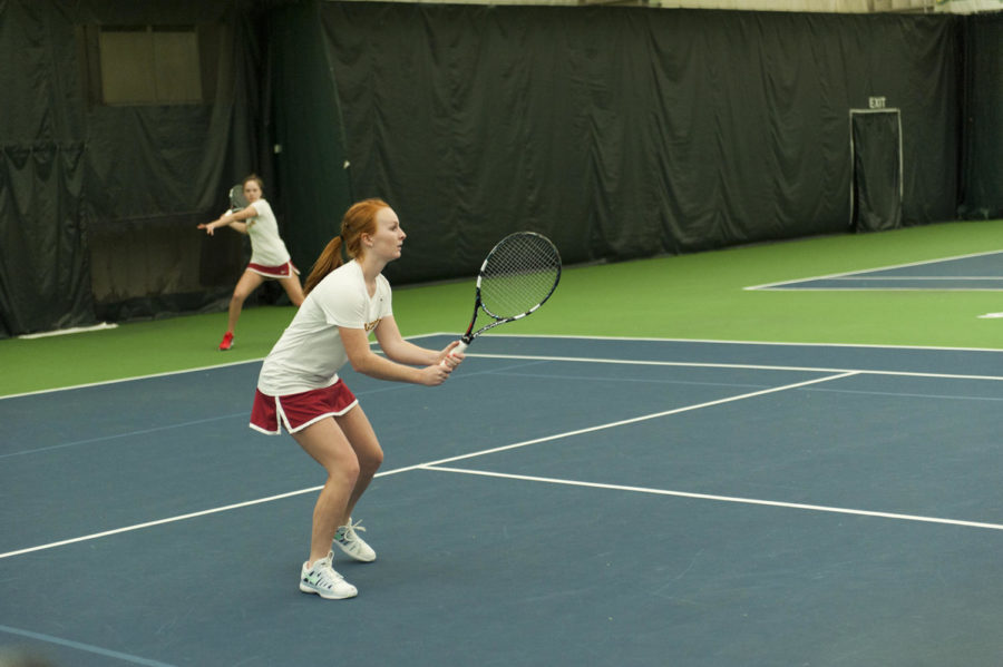 Junior Meghan Cassens readies for the return as her partner, sophomore Ana Gasparovic, serves during Iowa States meet against TCU at Ames Racquet and Fitness on Friday, March 28.