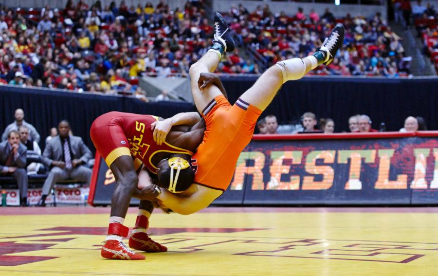 Earl Hall throws Virginia Tech red shirt freshman Kevin Norstrem to the mat. Iowa State defeated Virginia Tech 21-12 Jan. 18, 2015.