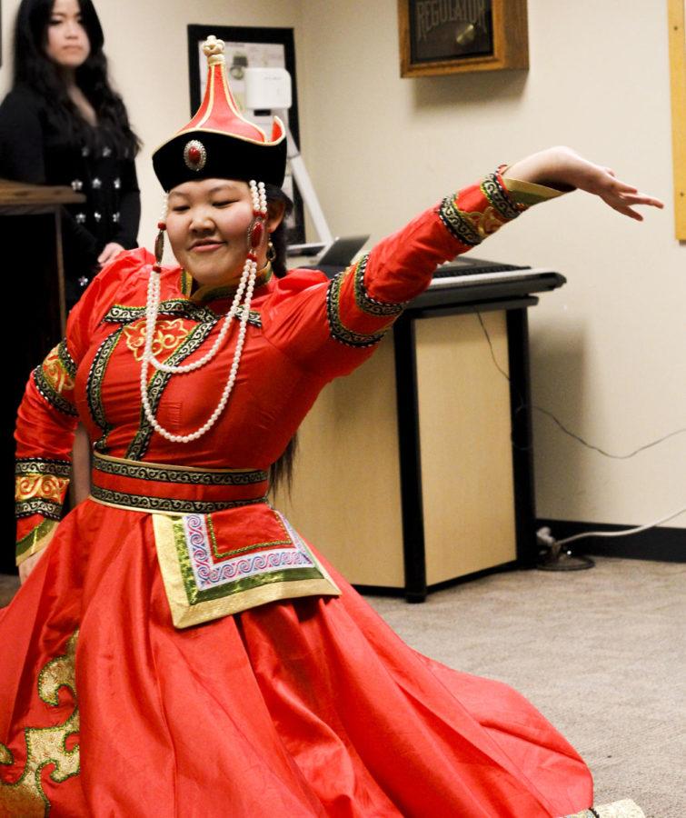 Terigele, a graduate student, performs a traditional dance from Chinese culture in part of the celebration at the Greenlee School of Journalism and Communication on Feb. 7, 2014. Students and faculty gathered to commemorate the Chinese New Year by eating and watching performances from a multitude of students.  