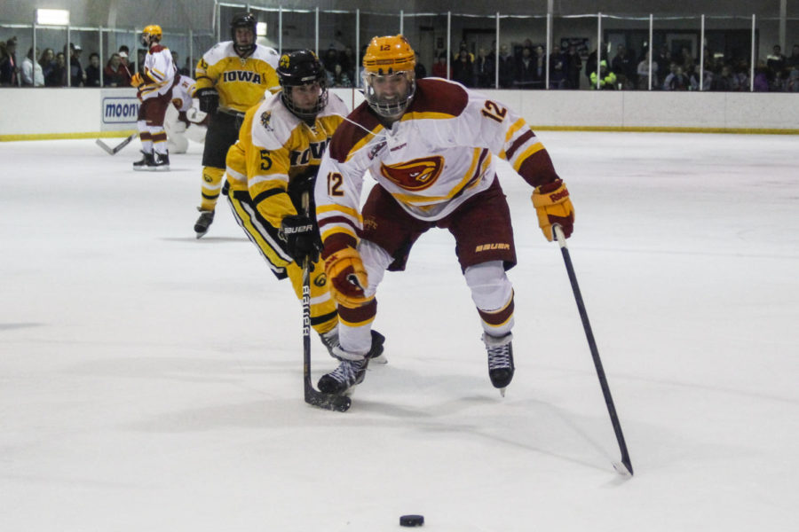 Sophomore forward Preston Blanek chases after the puck during the game against Iowa on Jan. 23 at Ames/ISU Ice Arena. The Cyclones defeated the Hawkeyes 6-1.