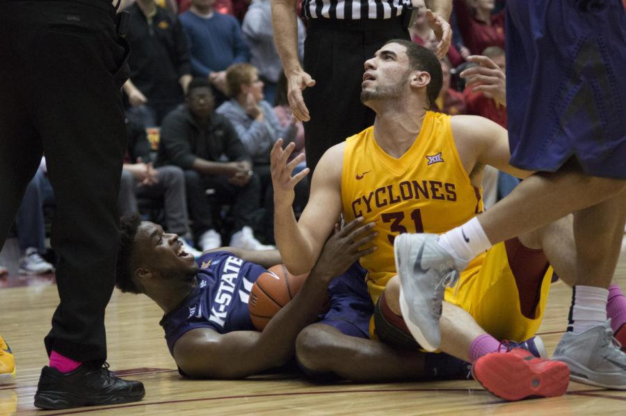 After scrambling for the ball, junior forward Georges Niang and Kansas States Nino Williams react to a call by the referees. Iowa State won the game 77-71.