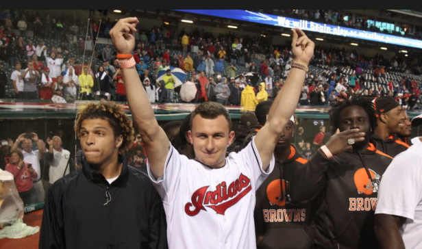 photo courtesy of cleveland.comJohnny Manziel shows his adopted gesture, the money sign, at a Cleveland Indians game against the Boston Red Sox at Progressive Field in June 2014. 