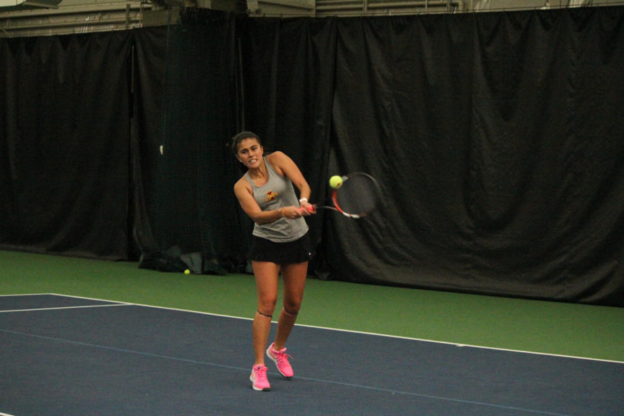Junior Alejandra Galvis returns the ball during singles play against Nebraska-Omaha on Jan. 30, 2015 at Ames Racquet and Fitness. The Cyclones swept the match 7-0.