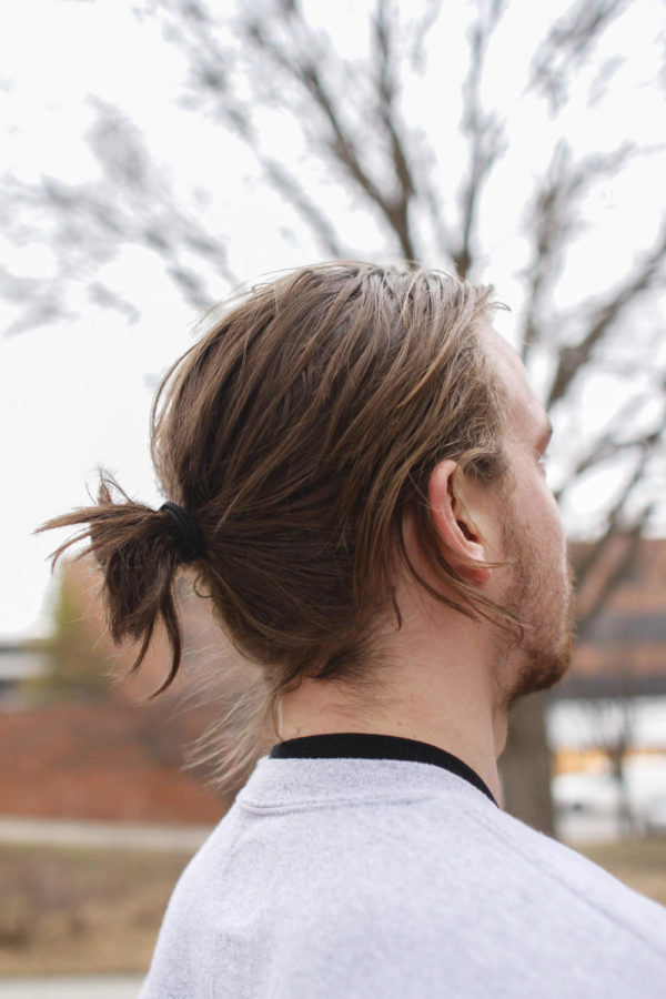 The man bun hair trend is gaining popularity with young men.