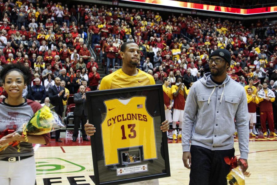 Senior Bryce Dejean-Jones holds his framed jersey before the game against No. 15 Oklahoma at Hilton Coliseum on March 2. The No. 17 Cyclones defeated the Sooners 77-70 after a rocky 18-point first half.