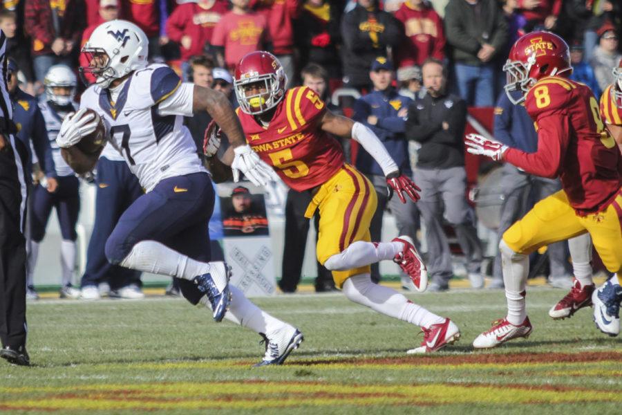 Reshirt junior defensive back Kamari Cotton-Moya goes after West Virginias Rushel Shell on Nov. 29 at Jack Trice Stadium. The Cyclones fell to the Mountaineers 37-24.