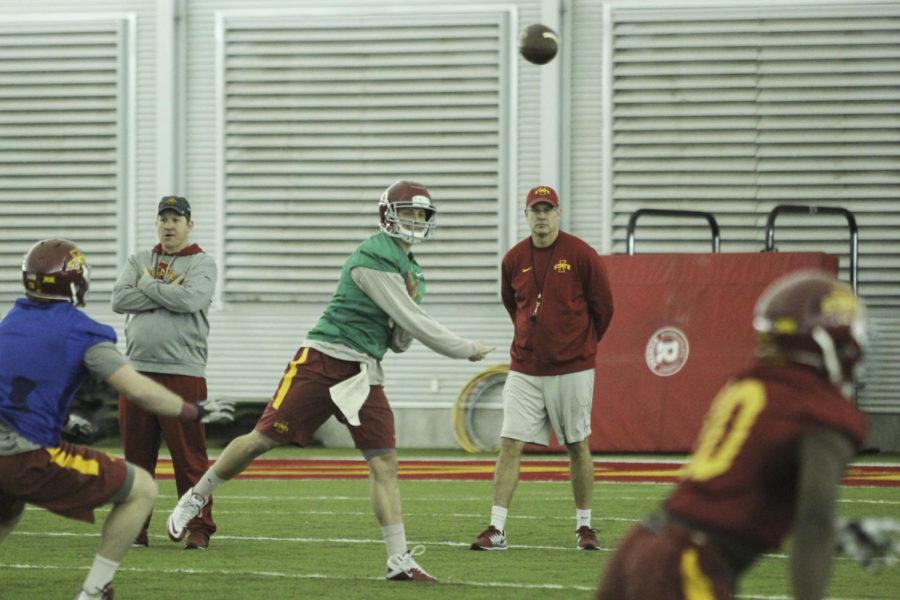 Redshirt junior quarterback Grant Rohach passes the ball at the first football practice March 3 at Bergstrom Indoor Practice Facility.