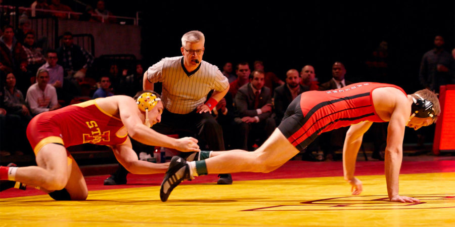 Redshirt junior Tanner Weatherman pulls his opponent back into the fight. Weathermans pin helped Iowa State to a 30-16 victory against Wisconsin.