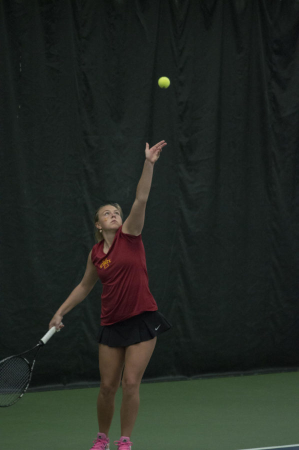 Senior Ksenia Pronina serves the ball during the tennis match between Iowa State and Texas. Texas won the match 4-2.