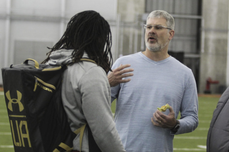 Coach Paul Rhoads talks with EJ Bibbs after Pro Day on Tuesday, March 24. Twenty-seven NFL scouts came to watch ISU athletes.