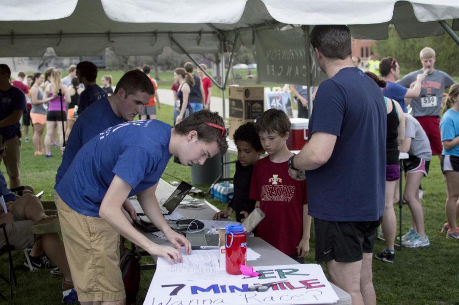 Delta Sigma Phi coordinators register and hand out numbers to the runners of the 4k Hay Run for Cancer on April 17.