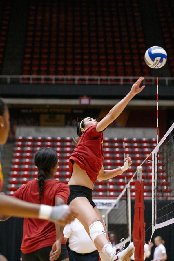 Redshirt senior middle blocker Tory Knuth taps the ball over the net while playing in the ISU spring tournament on April 18.