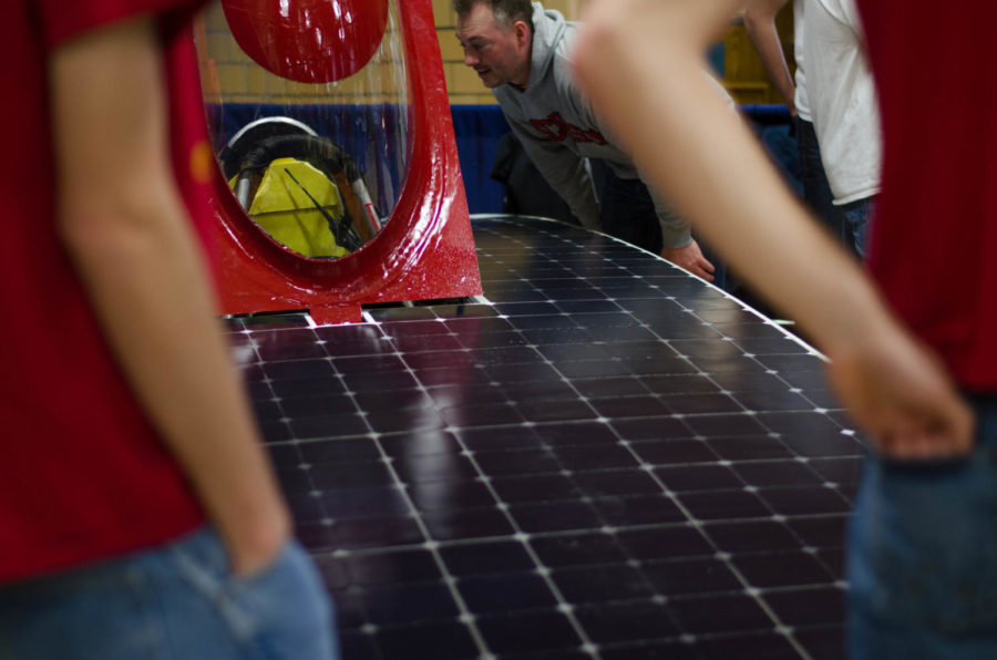 Team PrISUm shows off its solar car at the Ames Eco Fair on Saturday. The Eco Fair was held at the Ames Community Center and invited the community to learn about conservation and living eco-friendly