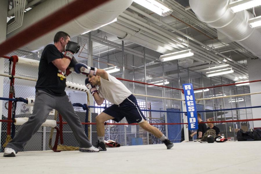 Junior Josue Avila, right, practices in the ISU Boxing Clubs practice ring at State Gym on April 2. Avila will compete at the 2015 NCBA National Championships in Sunrise, Fla., in the 139-pound weight class.