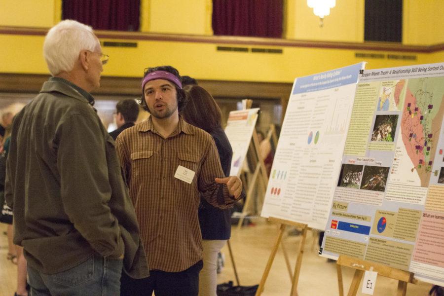 Win Cowger presents his research about trash accumulation in streams during the Honors Program spring poster presentation in the Great Hall on April 29, 2015. 