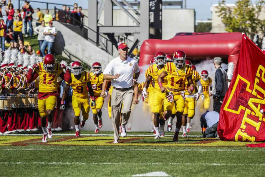 Coach Paul Rhoads and the Iowa State football team run onto the field before the Homecoming game against Toledo on Oct. 11 at Jack Trice Stadium. The Cyclones defeated the Rockets 37-30.