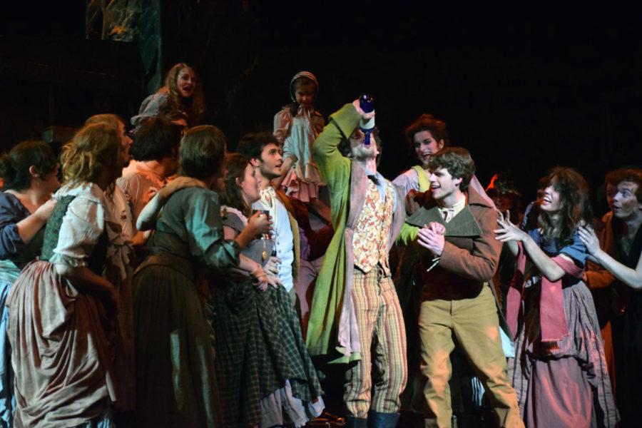 The Cast of Les Misérables surrounds Thénardier, played by senior Christopher Kent, during a rehearsal on Tuesday, April 7.