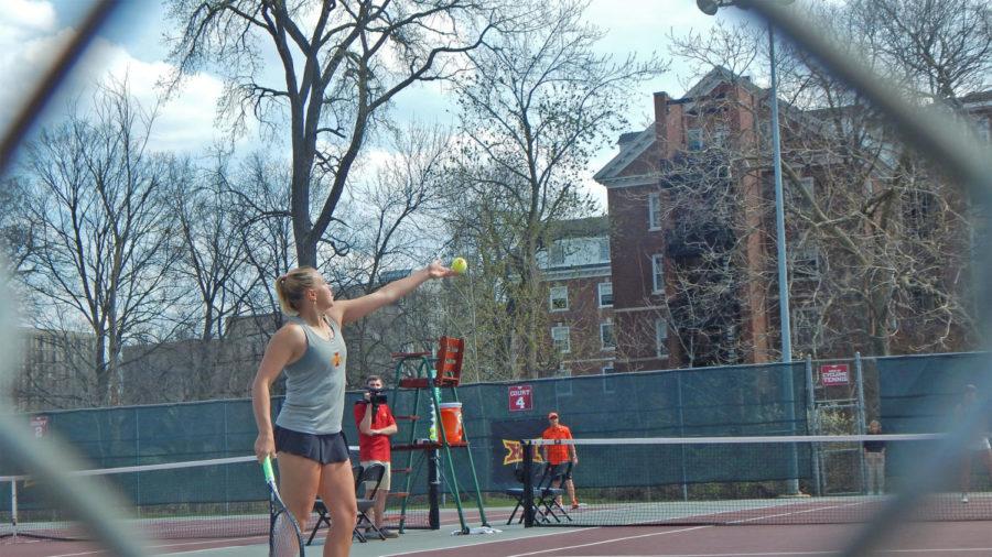 Senior Ksenia Pronina begins her serve during her doubles match against No. 10 Oklahoma State. Oklahoma State defeated Iowa State 4-0.