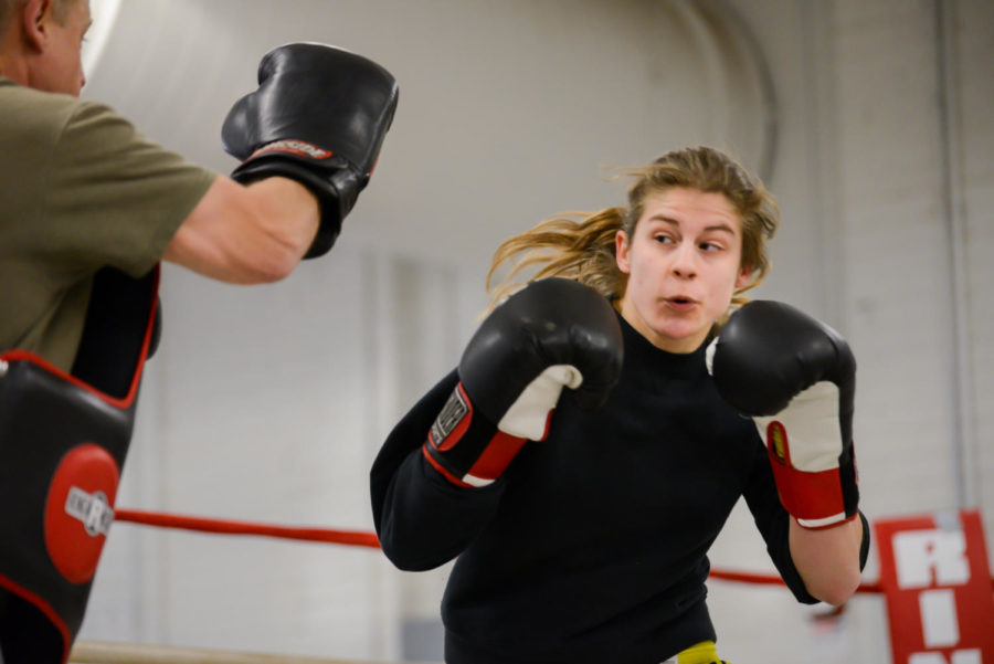 Olivia Meyer, junior in biology, practices with boxing coach Jon Swanson on April 1, 2014, in State Gym. She is going to compete in her first NCBA National Championships on April 3-5 in West Point, N.Y. 
