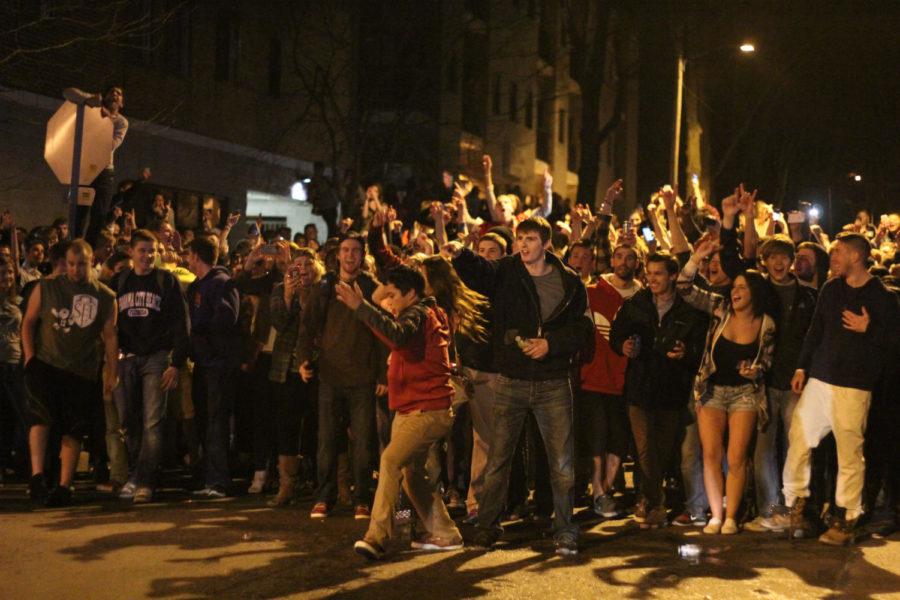 A crowd faces police at the intersection of Chamberlin Street and Stanton Avenue during Veishea on Tuesday, April 8.