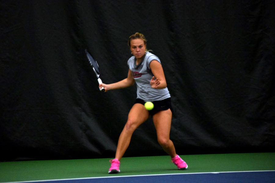 Senior Ksenia Pronina hits the ball during practice at the Ames Racquet and Fitness Center on Tuesday.
