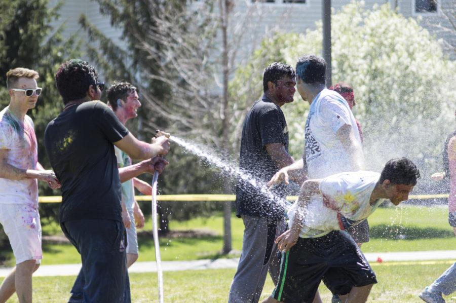 Participants of the 2015 Holi celebration throw colored dust and spray water on one another April 26. The celebration was organized by the Indian Students' Association.