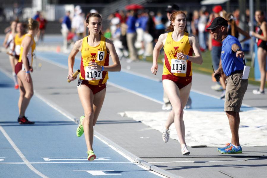 Freshman Abby Caldwell gets the handoff from graduate student Kate DeSimone in the womens 4x1600-meter relay at the Drake Relays on April 23 in Des Moines. The team finished third overall with a time of 19:23.90.