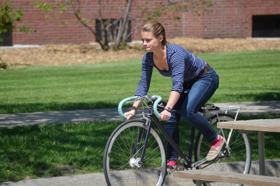 An ISU student heads home on her bike after a meeting in Kildee Hall. The Ames Bicycle Coalition is celebrating Bike to Work Week from May 11 to 15, and Friday is Bike to Work Day.