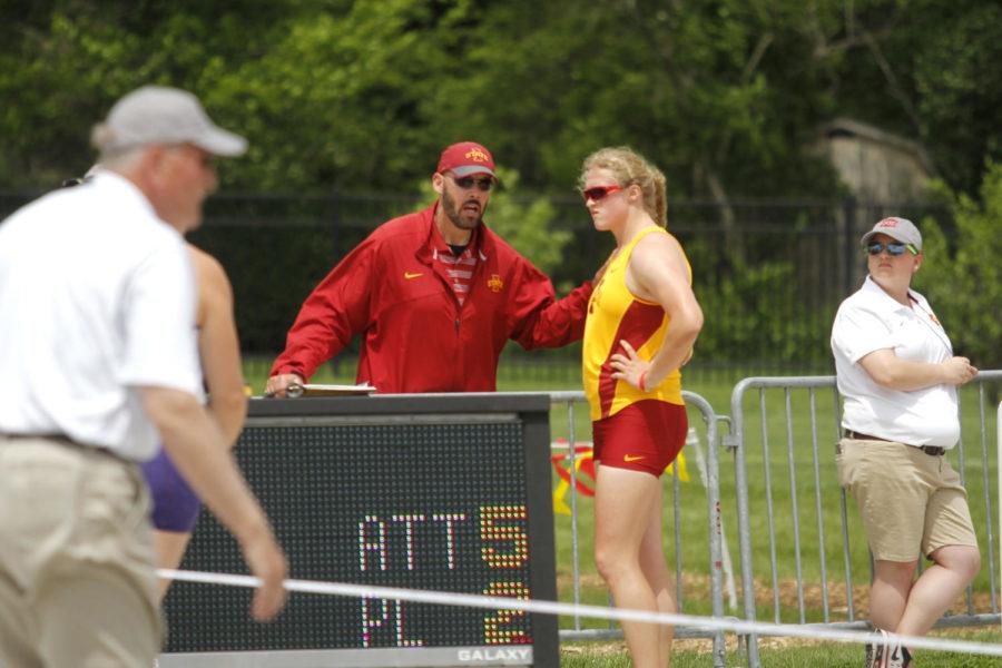 Senior Christina Hillman (right) talks with her coach, Fletcher Brooks (left), in between throws at the Big 12 Outdoor Championships at the Cyclone Sports Complex in Ames on May 16, 2015. Hillman finished second overall in the shot put.