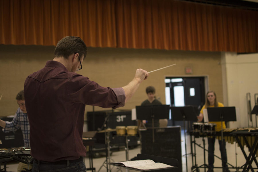 Music lecturer Matthew Coley conducts a group of students during a rehearsal on March 13, 2015. Coley performed with Clocks in Motion at the Heartland Marimba Festivals marimba concert on Monday. 