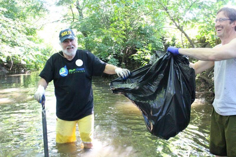 Volunteers+trudge+through+College+Creek+while+picking+up+trash+July+25.+The+clean-up+was+part+of+the+Live+Green%21+initiative+on+campus.